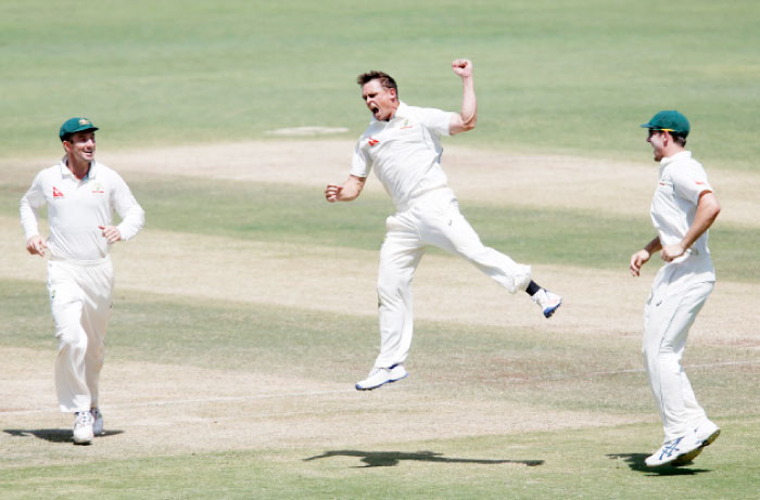 Australia’s Steve O’Keefe (C) celebrates with teammates the wicket of India’s captain Virat Kohli during their first Test cricket match in Pune Saturday. — Reuters