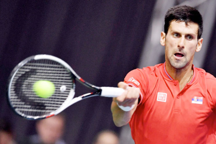 Serbia’s Novak Djokovic returns the ball to Russia’s Daniil Medvedev during their Davis Cup match at Cair Sports Hall in Nis Friday. — AFP