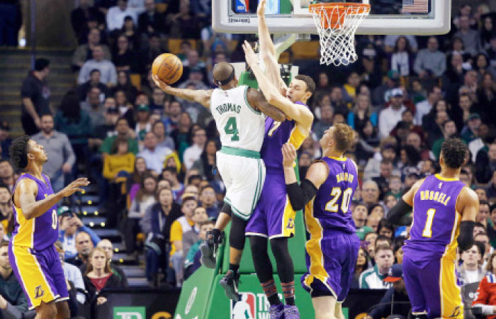 Boston Celtics’ Isaiah Thomas goes to the hoop against Los Angeles Lakers’ Larry Nance Jr. during their NBA game in Boston Friday. — AP