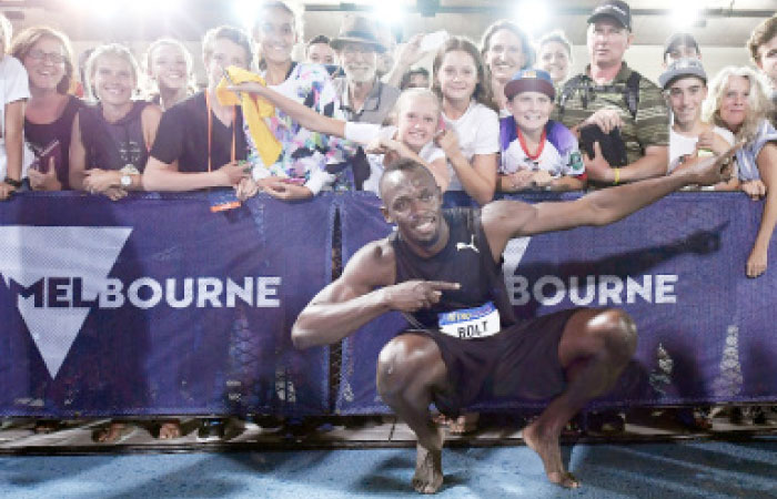 Jamaica’s Usain Bolt poses for a photo with fans after competing in the mixed 4x100-meter relay at the Nitro Athletics meet in Melbourne Saturday. — AP