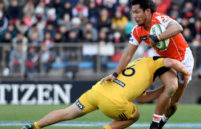 Ryohei Yamanaka of the Sunwolves (R) is tackled by Dane Coles of the Hurricanes during their Super Rugby match at the Prince Chichibu Memorial stadium in Tokyo Saturday. — AFP