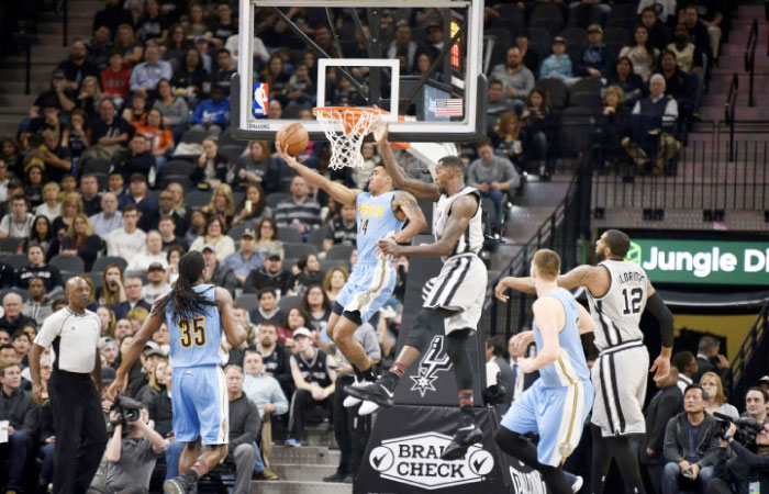 Denver Nuggets’ guard Gary Harris shoots against San Antonio Spurs’ center Dewayne Dedmon during their NBA game at the AT&T Center in San Antonio Saturday. — Reuters