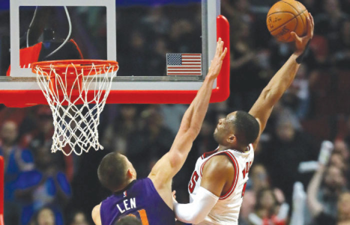 Dwyane Wade of the Chicago Bulls goes up for a dunk over Alex Len of the Phoenix Suns at the United Center in Chicago, Illinois, Friday. — AFP