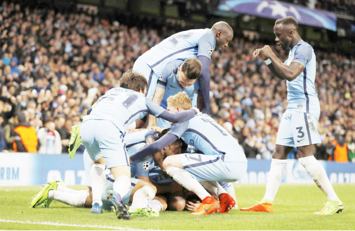 Manchester City players celebrate scoring their fifth goal against Monaco during their Champions League match in Manchester Tuesday. — Reuters