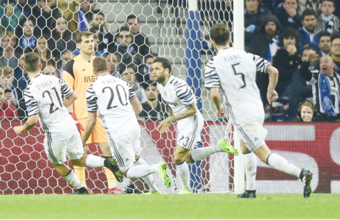 Juventus’ defender Dani Alves (2nd R) celebrates after scoring against FC Porto during their UEFA Champions League round of 16 second leg football match at the Dragao Stadium in Porto Wednesday. — AFP