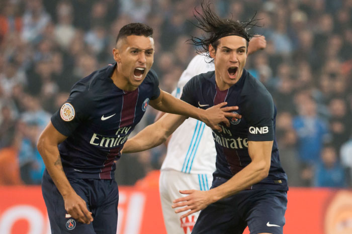 Paris Saint-Germain’s Brazilian defender Marquinhos (L) and Paris Saint-Germain’s Uruguayan forward Edinson Cavani celebrate after scoring a goal during the French L1 football match on Sunday at the Velodrome stadium in Marseille. — AFP