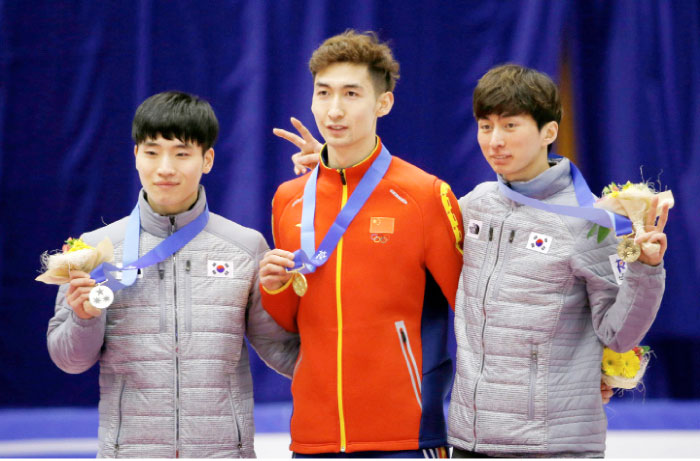 Gold medalist Wu Dajing (C) of China poses with silver medalist Seo Yira (L) and bronze medalist Park Se-yeong of South Korea in a medal ceremony for the men’s 500 m short track at the Asian Winter Games in Sapporo.  — Reuters