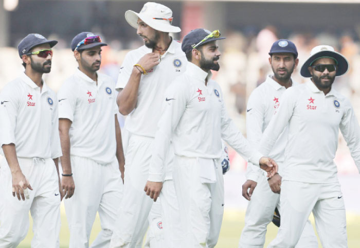 Indian players, led by skipper Virat Kohli (3rd R), leave the ground at the end of play on the second day of the cricket Test match against Bangladesh in Hyderabad Friday. — AP