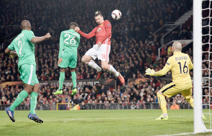 Manchester United’s striker Zlatan Ibrahimovic (C) heads the ball against Saint-Etienne during their UEFA Europa League match at Old Trafford Stadium in Manchester Thursday. — AFP