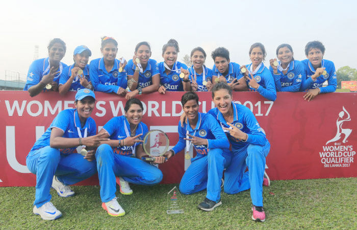 Members of the Indian cricket team pose for photographs with the winners trophy after defeating South Africa in their ICC Women’s World Cup Qualifier final One-Day International cricket match in Colombo, Sri Lanka, Tuesday. — AP