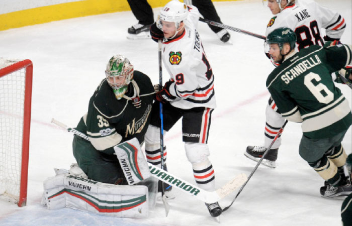 Chicago Blackhawks’ center Jonathan Toews (2nd L) scores on Minnesota Wild goalie Darcy Kuemper (l) in overtime during their NHL game at Xcel Energy Center in Saint Paul, Minnesota, Wednesday. — Reuters