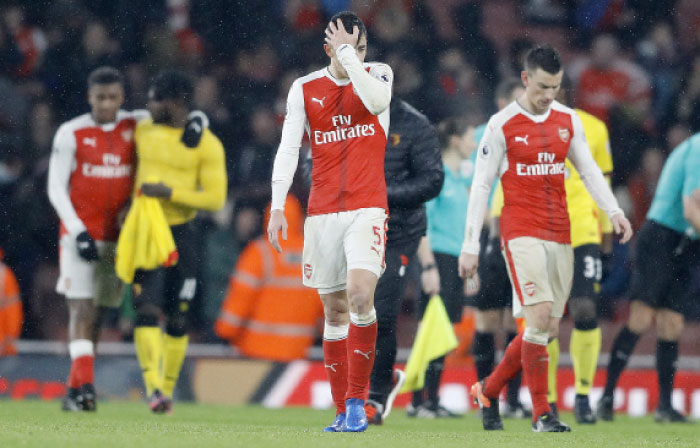 Arsenal players react after losing their English Premier League soccer match against Watford at the Emirates Stadium in London, Tuesday. — AP