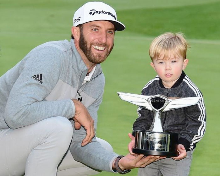 Dustin Johnson and his son Tatum pose with the trophy during the final round at the Genesis Open at Riviera Country Club on Sunday in Pacific Palisades, California. — AFP