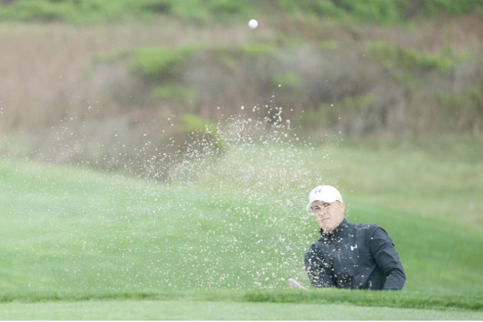 Jordan Spieth hits from the bunker on the 12th hole during the first round of the AT&T Pebble Beach Pro-Am at Monterey Peninsula Country Club in Pebble Beach, California, Thursday. — AFP