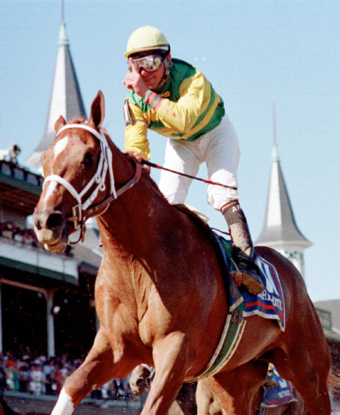 In this file photo, jockey Chris Antley gestures aboard Charismatic after crossing the finish line to capture the 125th running of the Kentucky Derby in Louisville, Ky. — AP