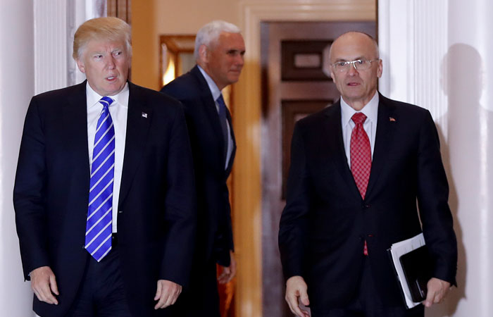 File photo shows President-elect Donald Trump walks Labor Secretary-designate Andy Puzder from Trump National Golf Club Bedminster clubhouse in Bedminster, N.J. Puzder said Tuesday that a housekeeper he had previously employed at his home was an undocumented worker, potentially complicating his efforts to get confirmed. — AP