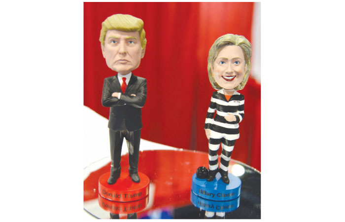 A Donald Trump bobblehead doll is displayed beside one of former secretary of state Hillary Clinton in prison garb at a booth during the Conservative Political Action Conference (CPAC) at National Harbor, Maryland, Thursday.  Politicians, pundits, journalists and celebrities gather for the annual conservative event to hear speakers, network and plan agendas for the new President Trump administration. — AFP