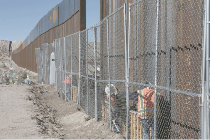 Workers continue work raising a taller fence in the Mexico-US border separating the towns of Anapra, Mexico, and Sunland Park, New Mexico, in this Jan. 25, 2017 file photo. — AP