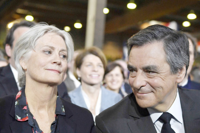 French rightwing candidate for the upcoming presidential election Francois Fillon (right) flanked by his wife Penelope, looking on during a campaign rally in Paris. Fillon’s campaign has been struggling since it emerged that his Welsh-born wife Penelope was paid 830,000 euros (900,000 USD) as a parliamentary assistant over more than a decade ‑ despite almost no one recalling her on the job. — AFP