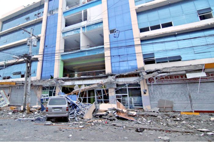 Debris falls on a car after a strong earthquake hit Surigao city, southern Philippines, on Saturday. — Reuters