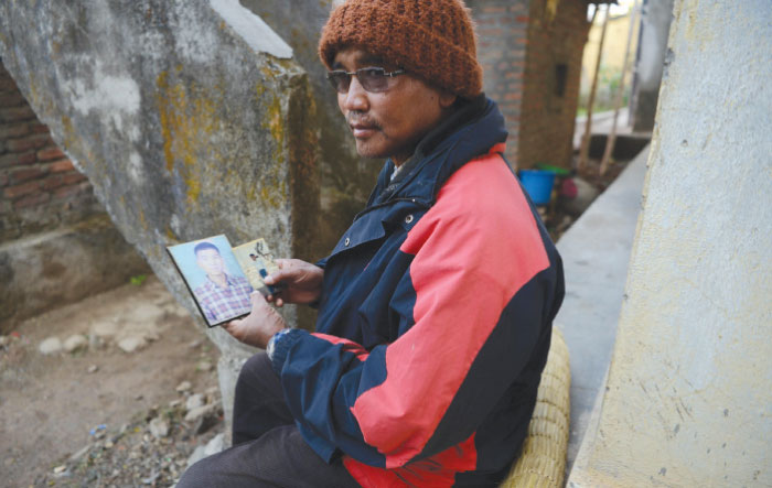 Nepalese war victim Kabiram Sunakhari shows a photograph of his son as she speaks during an interview with AFP in Birendranagar, Surkhet District, some 520 km west of Kathmandu. — AFP