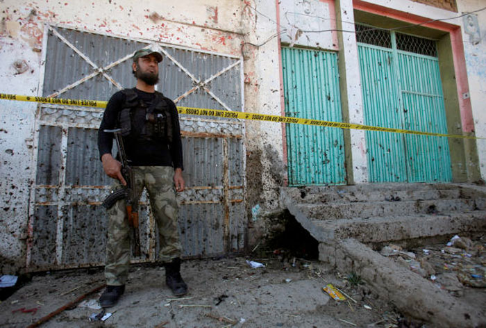A soldier stands guard at the site of a blast at the courthouse in Charsadda, Pakistan, on Tuesday. — Reuters