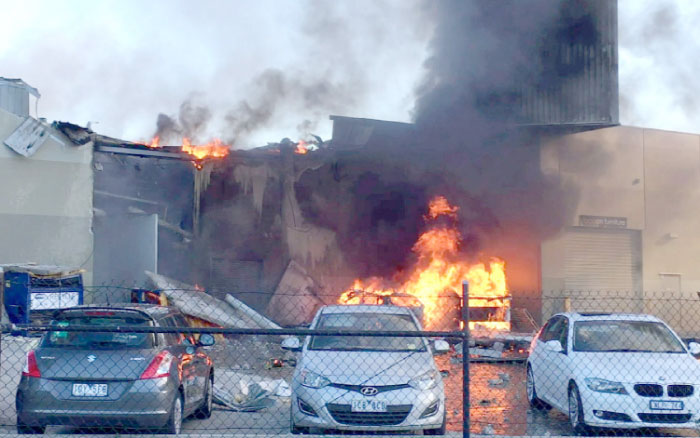 This frame grab taken from AFPTV of video received from Jordan Fouracre on Tuesday shows smoke and flames after a twin-engined Beechcraft plane crashed into a shopping center just after takeoff from Essendon Fields airport near Melbourne, Australia. — AFP