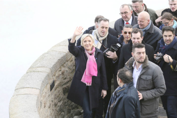 French Far-right leader presidential candidate Marine Le Pen waves during a visit in Le Mont Saint Michel, north western France, on Monday. — AP