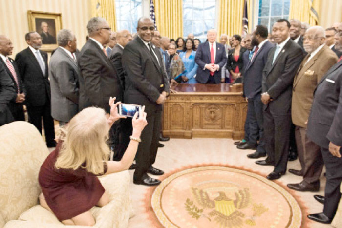 Counselor to the President Kellyanne Conway takes a photo as US President Donald Trump and leaders of historically black universities and colleges talk before a group photo in the Oval Office of the White House before a meeting with US Vice President Mike Pence in Washington, D.C., on Monday. — AFP