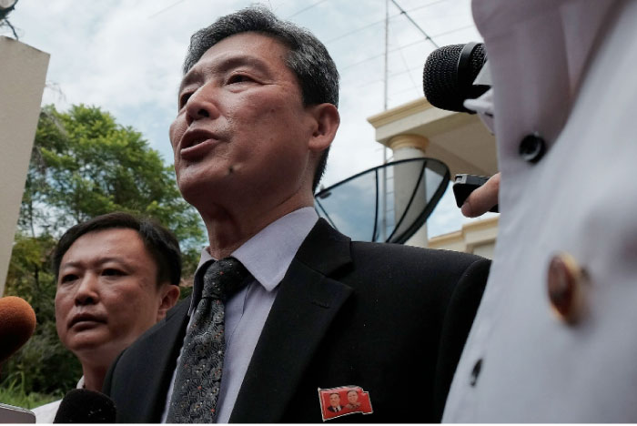 Former North Korean deputy ambassador to the United Nations, Ri Tong Il, center, addresses journalists outside the North Korean embassy in Kuala Lumpur on Tuesday. — AFP
