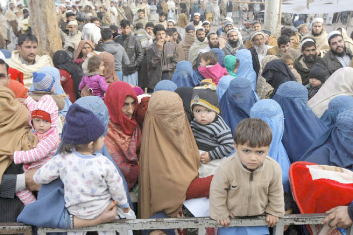 Afghan refugee families wait for their turn to be registered, outside the government registration office in Peshawar, Pakistan, in this Feb. 8, 2017 file photo. — AP