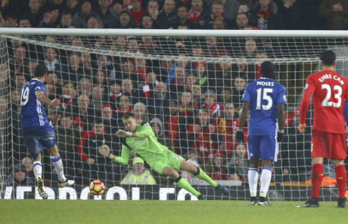 Chelsea’s Diego Costa (L) has a penalty shot saved by Liverpool’s goalkeeper Simon Mignolet during their English Premier League match at Anfield stadium in Liverpool Tuesday. — AP