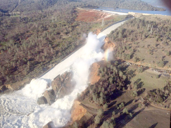 A damaged spillway with eroded hillside is seen in an aerial photo taken over the Oroville Dam in Oroville, California, on Sunday. — Reuters