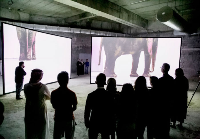 Visitors view a presentation at the Art of Jeddah 21,39 exhibition titled “Safar” at King Abdullah Economic City in Jeddah.