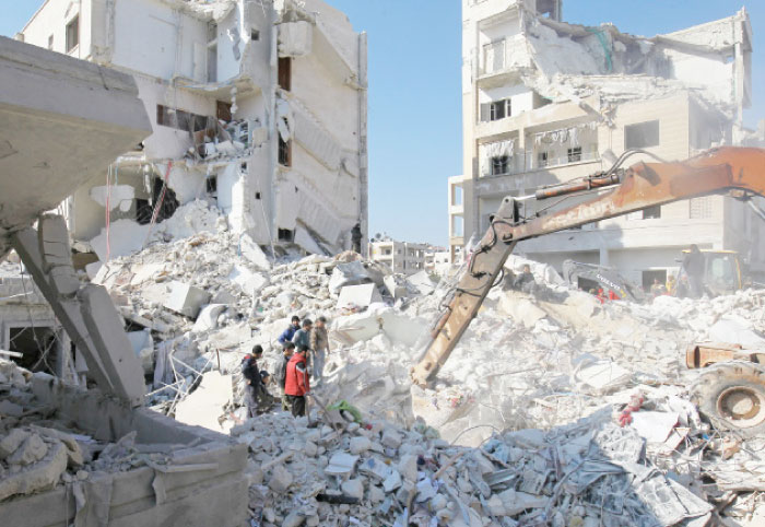 People search for survivors under the rubble of a site hit by air strikes in the rebel-held city of Idlib on Tuesday. — Reuters