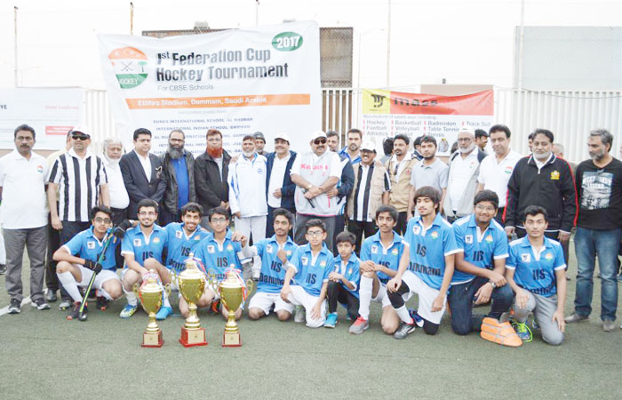 Champions, International School Dammam, with there trophy and match officials. — Courtesy photo