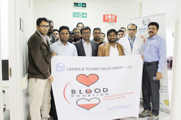 Blood donors pose for a photo.