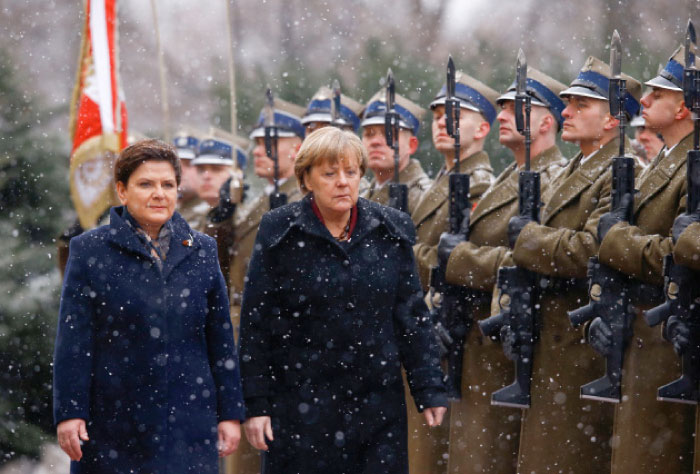 German Chancellor Angela Merkel and Poland’s Prime Minister Beata Szydlo review the guard of honour during the welcoming ceremony in Warsaw, Poland on Tuesday. — Reuters