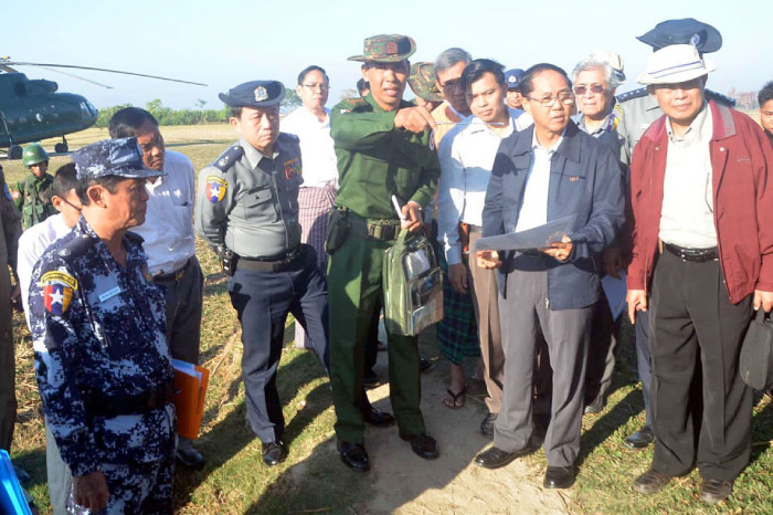 This file handout photograph shows a military official (C) briefing Myanmar Vice President Myint Swe (2nd R, in blue jacket), head of the Rakhine State Investigation Commission, during his visit to Gwazon, a Muslim majority village in Maungdaw located in Rakhine State near the Bangladesh border.  — AFP