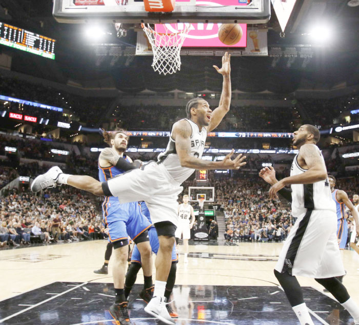 Kawhi Leonard of the San Antonio Spurs scores against the Oklahoma City Thunder during their NBA game at AT&T Center in San Antonio Tuesday. — AFP