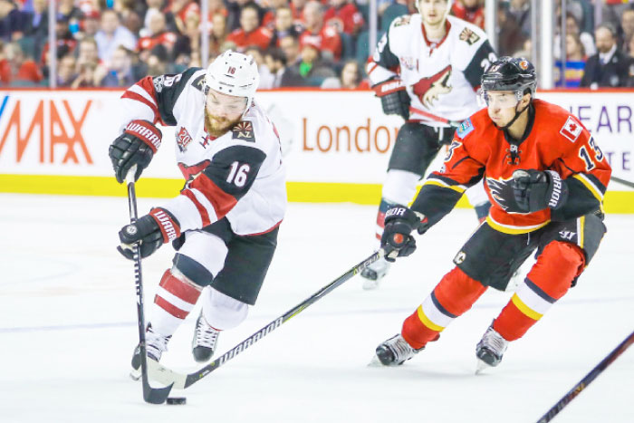 Arizona Coyotes left wing Max Domi (16) and Calgary Flames left wing Johnny Gaudreau (13) battle for the puck during the second period at Scotiabank Saddledome. — Reuters
