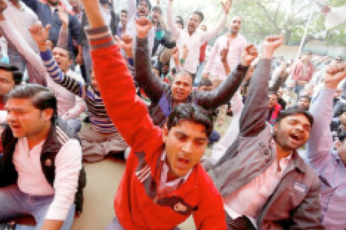 Uber and Ola drivers shout slogans during a protest in New Delhi, India, on Monday. — Reuters