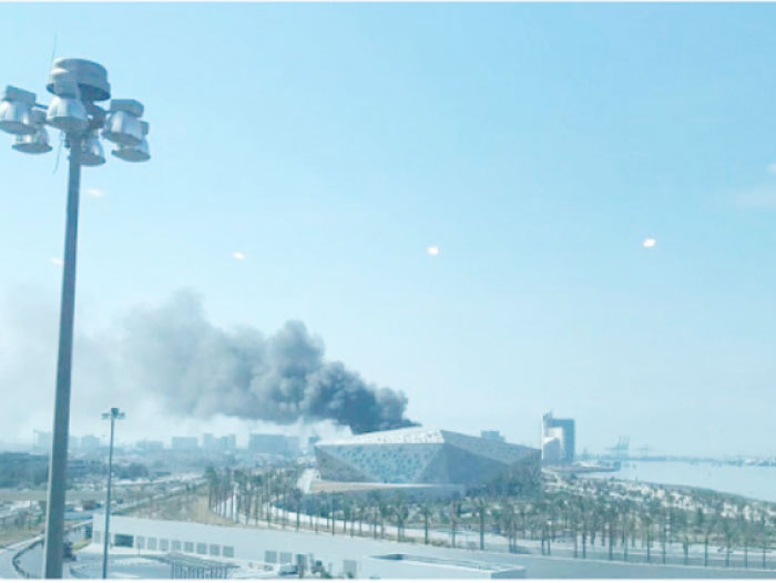 A thick plume of black smoke rises from the waterfront Sheikh Jaber Al Ahmad Cultural Center.