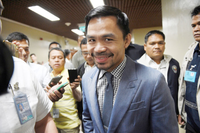 Philippine boxing icon and Senator Manny Pacquiao arrives for a senate session in Manila on Monday. Pacquiao  asked his legions of Twitter followers to choose his opponent after announcing his next world title defense will be in the United Arab Emirates. — AFP
