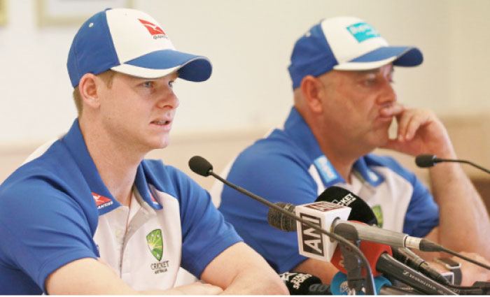 Australia’s cricket captain Steven Smith speaks, left, as head coach Darren Lehmann looks on during a news conference in Mumbai, India, Tuesday. — AP