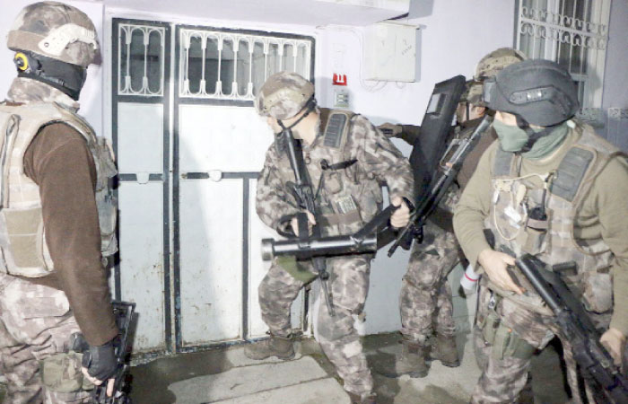 Turkish anti-terrorism police break a door during an operation to arrest people over alleged links to the Daesh group, in Adiyaman, southeastern Turkey. — AP