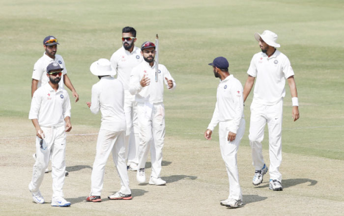 India’s captain Virat Kohli, center, tosses a wicket into the air to celebrate their win over Bangladesh in their one-off cricket test match in Hyderabad, India, Monday.— AP