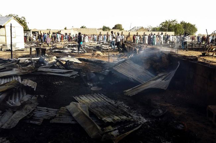 Residents of the Muna camp gather near the site of an explosion on Wednesday. — AFP