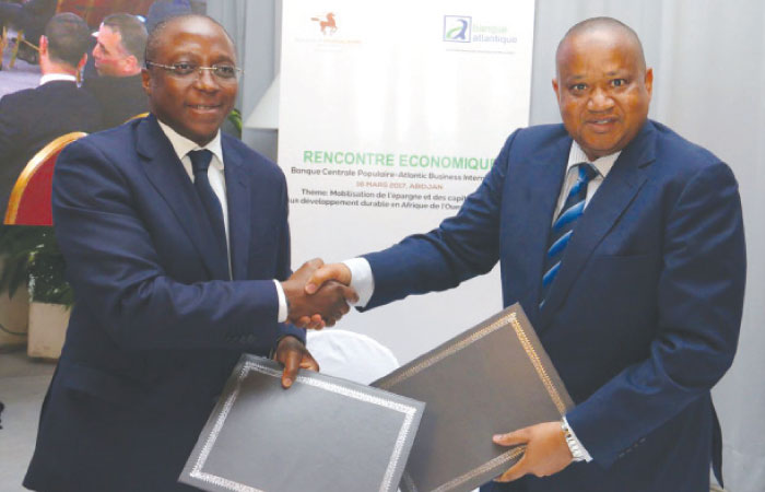 Abou Jallow, General Manager at ITFC, and Habib Kone, General Manager of ABI, shake hands after the signing of agreement