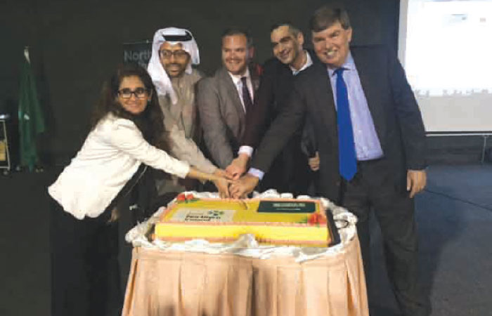 Consul General Barrie Peach,Wissam Saadi along with Amna Ali, business development manager, Invest Northern Ireland and other businessmen cutting the ceremonial cake.